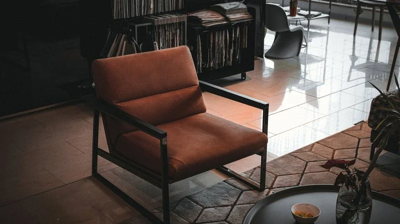 A quiet listening room, low seating, warm afternoon light, vinyl storage within reach