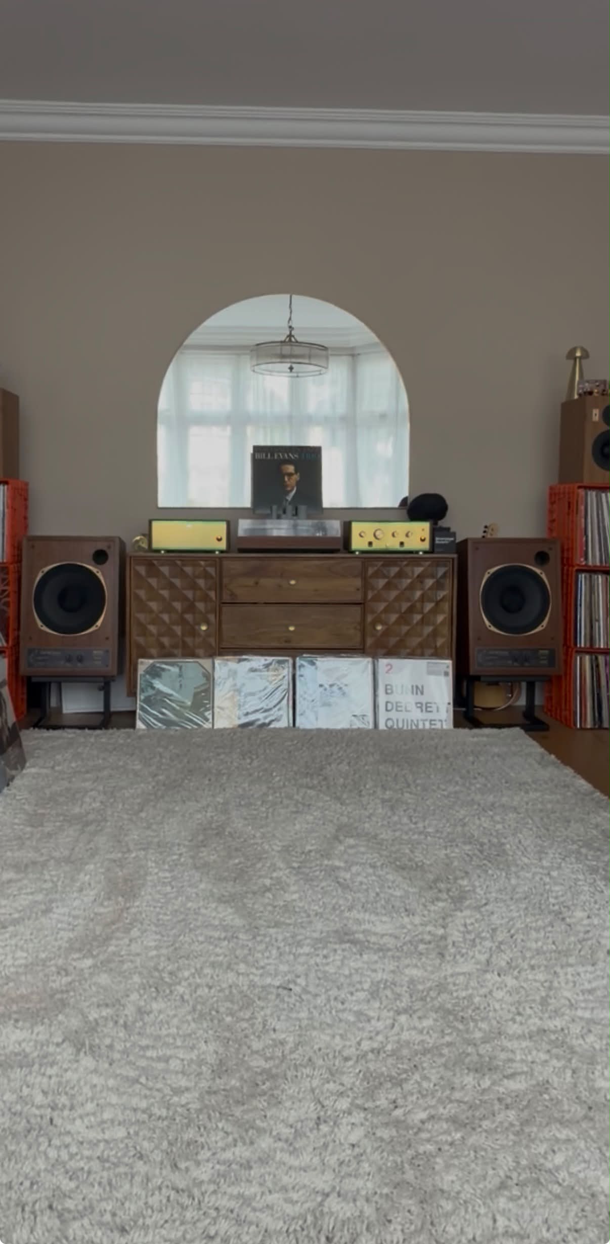 Records leaning against the sideboard, on the shag pile rug
