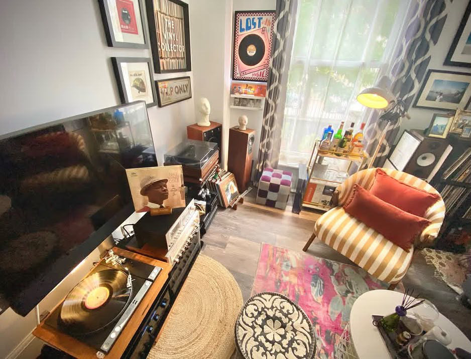 Overhead view of the room by daylight, gallery wall of record-themed frames
